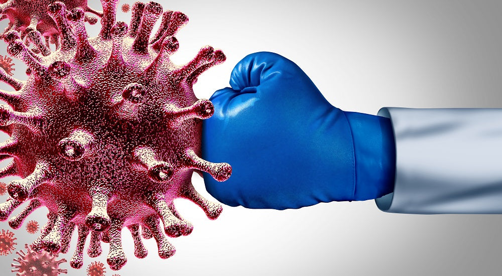 a giant germ being punched by a hand of a doctor wearing blue boxing gloves.